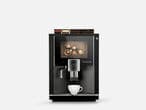 Der Kaffeevollautomat BARISTA Velluto von Kaffee Partner in der Frontansicht, der auf einem grauen Hintergrund abgebildet ist.