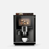 Der Kaffeevollautomat BARISTA Velluto von Kaffee Partner in der Frontansicht, der auf einem grauen Hintergrund abgebildet ist.